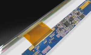 Close-up macro photography of a flexible PCB in mid-bend showing properly designed hatched copper ground plane patterns and curved trace routing parallel to the bend axis.